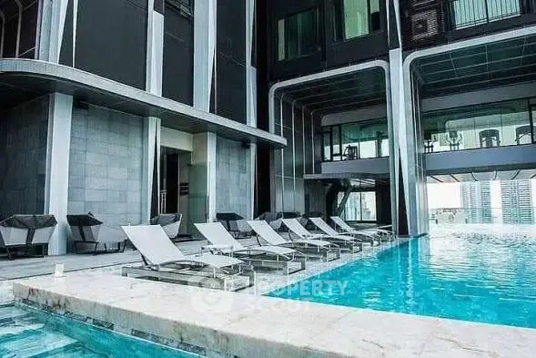 Luxurious modern building with stunning pool and sleek architecture.