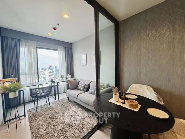 Modern living room with city view, cozy seating, and elegant dining area.