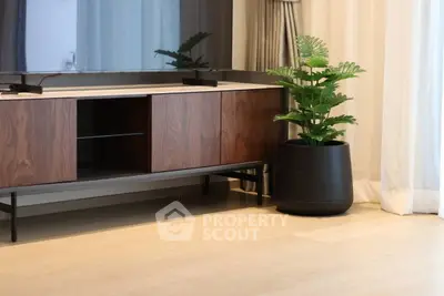 Modern living room with stylish TV stand and lush indoor plant