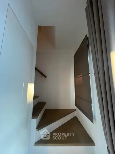 Modern staircase with minimalist design and sleek window shade