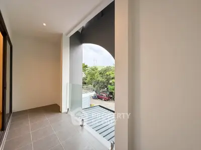 Spacious balcony with modern glass railing and scenic view