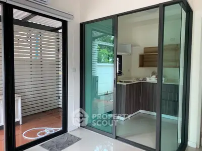 Modern kitchen with glass sliding doors and sleek cabinetry