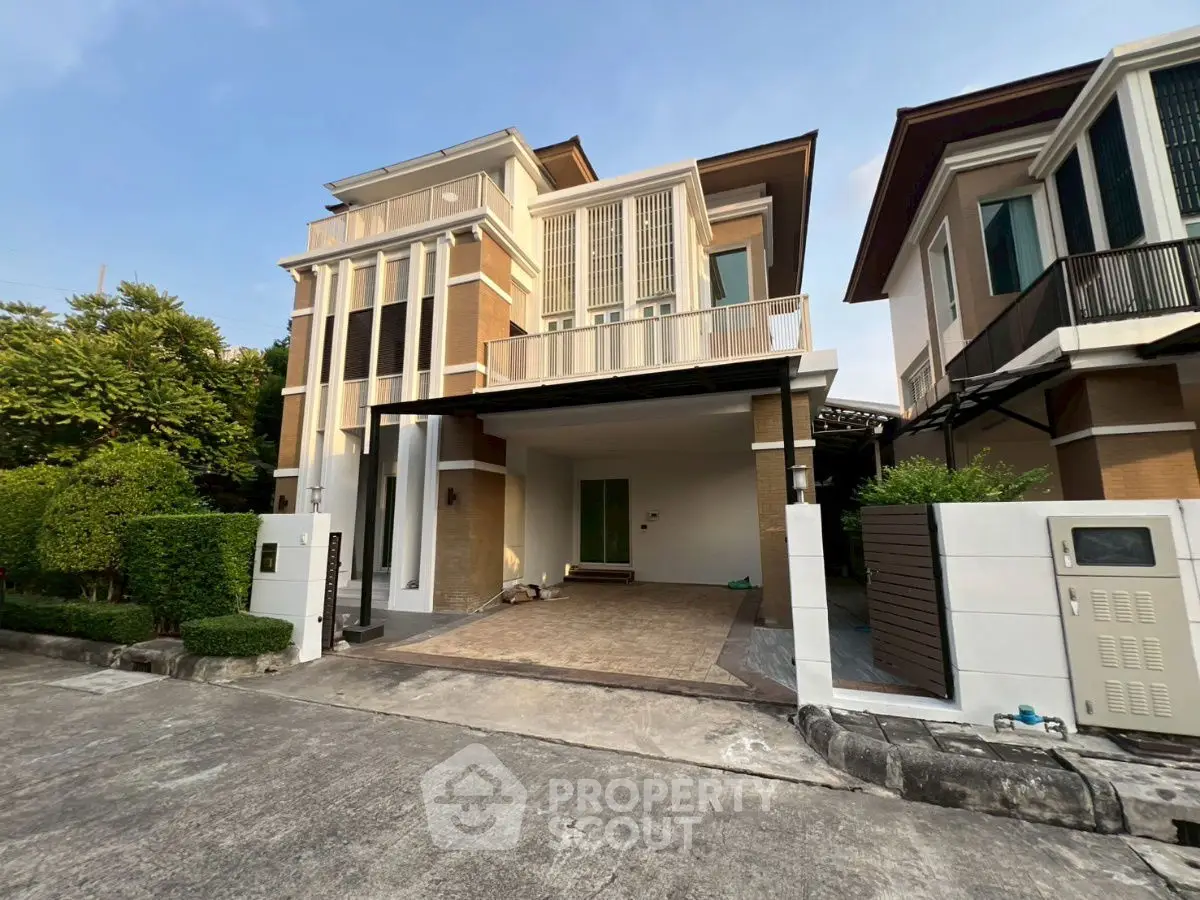 Modern two-story house with spacious driveway and lush greenery
