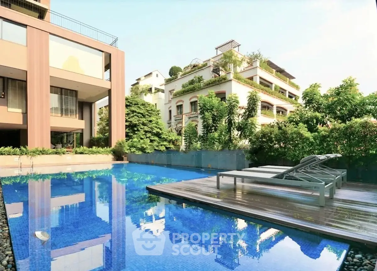 Luxurious residential building with stunning pool and lush greenery