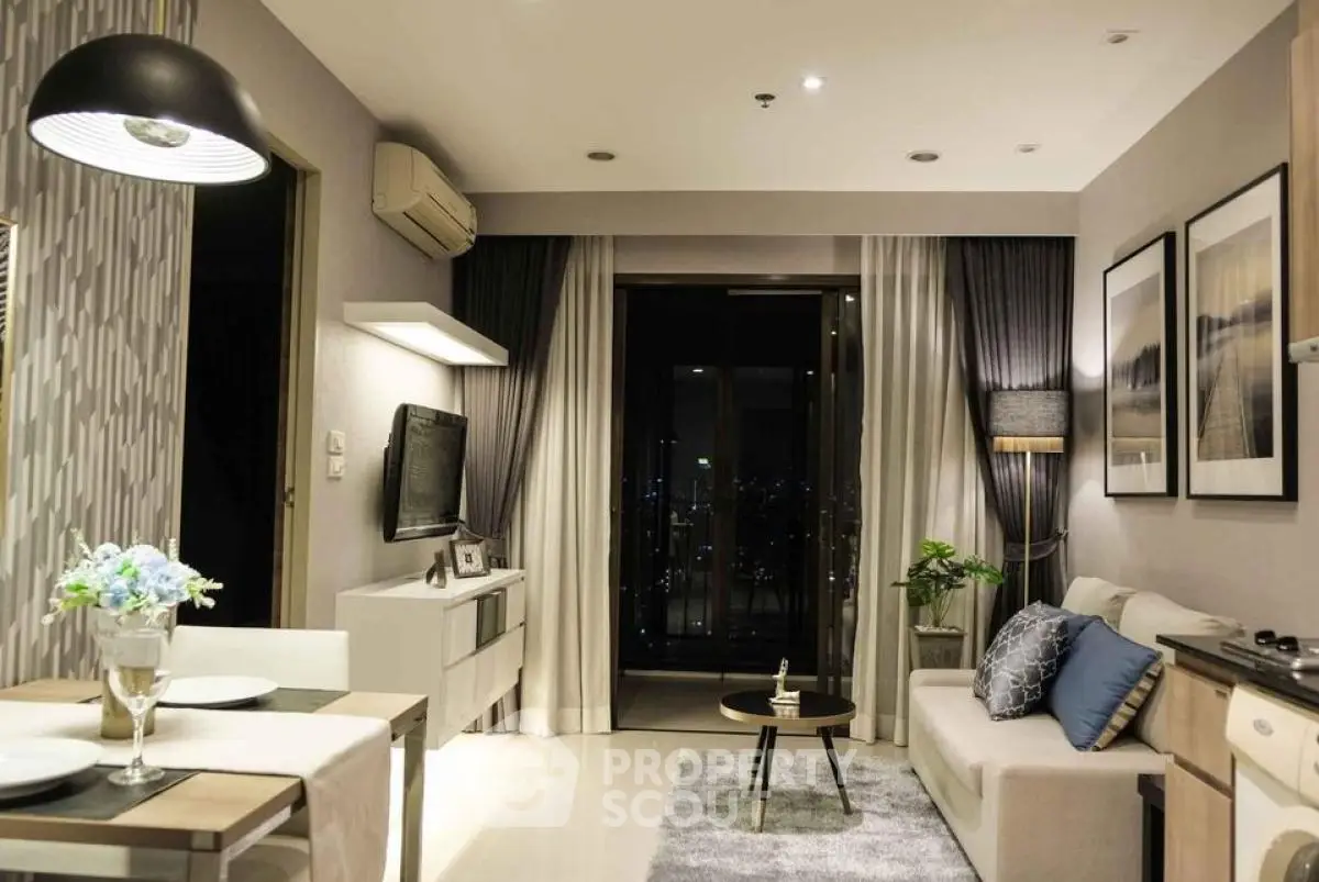 Modern living room with elegant decor and city view from balcony.