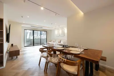 Spacious modern living room with elegant dining area and city view balcony.