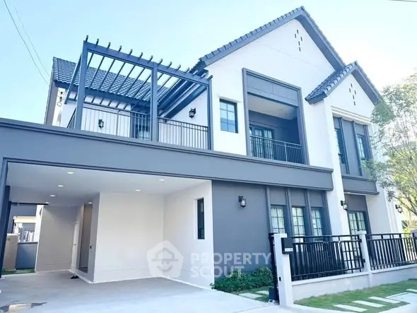 Modern two-story house with sleek design and spacious carport in a serene neighborhood.