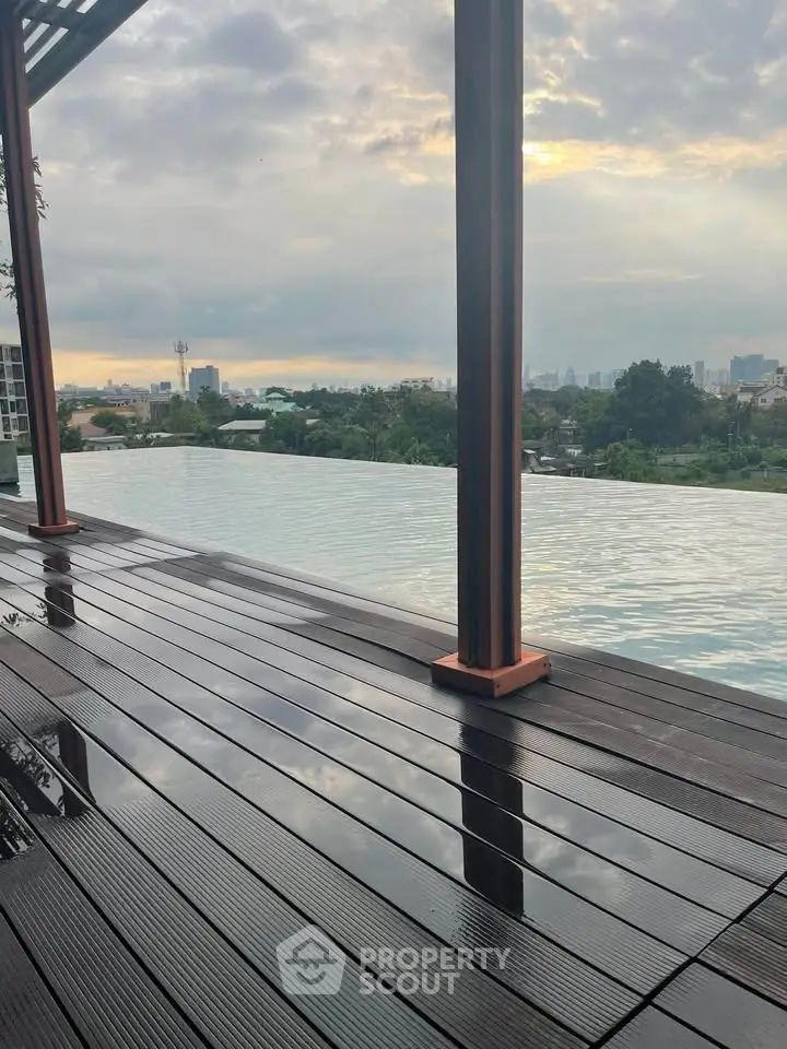 Stunning rooftop infinity pool with panoramic city views at sunset, perfect for luxury living.