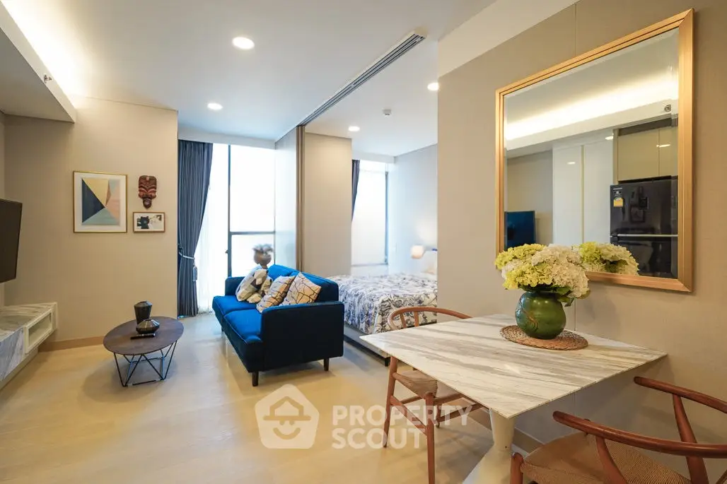 Modern open-plan living room with stylish decor and cozy seating area in a contemporary apartment.