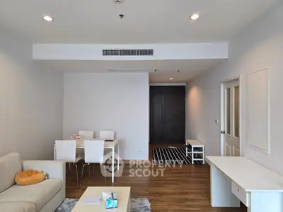 Spacious modern living room with elegant dining area and stylish decor, perfect for comfortable living.