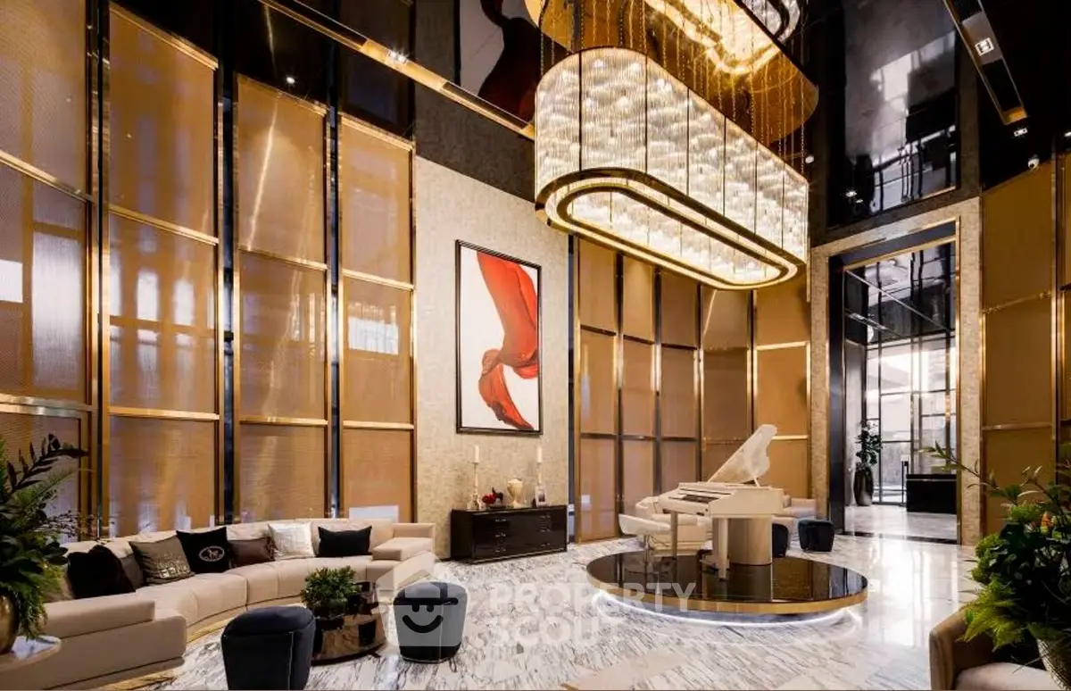 Luxurious living room with high ceilings, elegant chandelier, and modern decor.