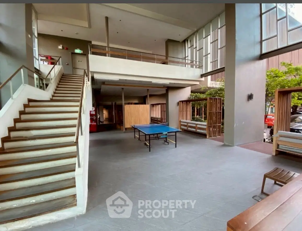 Spacious modern building interior with ping pong table and seating area