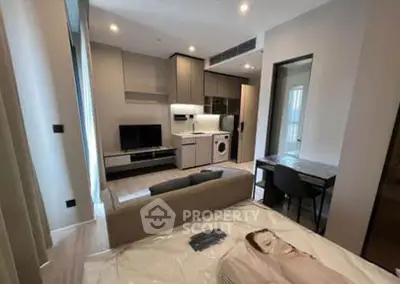 Modern studio apartment with open layout, featuring a cozy living area, compact kitchen, and stylish furnishings.