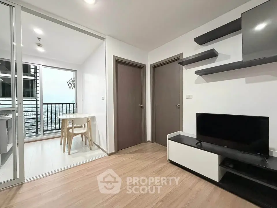 Modern living room with sleek TV unit and open balcony view