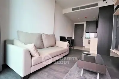 Modern living room with sleek furniture and open kitchen layout
