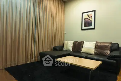 Cozy living room with elegant black sofa and modern decor