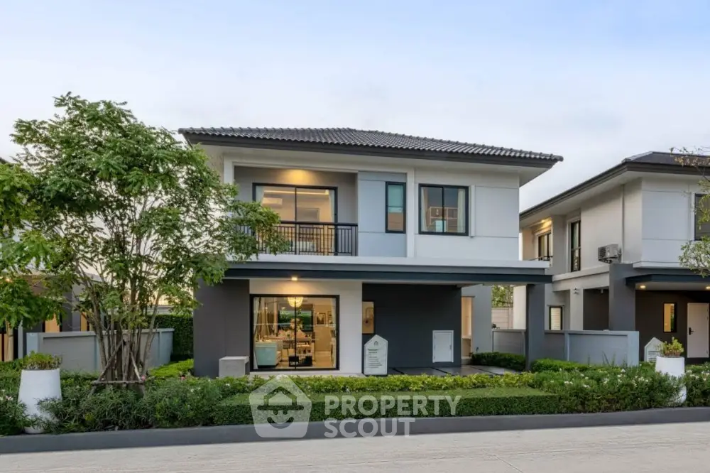 Modern two-story house with landscaped garden and contemporary design