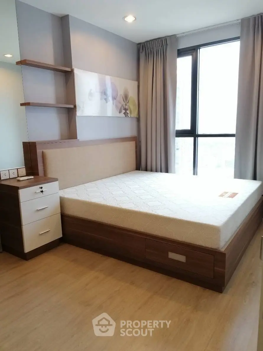 Modern bedroom with stylish wooden bed and large window view