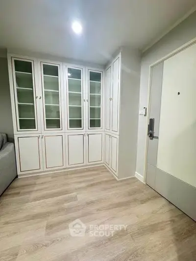 Modern interior with built-in storage cabinets and sleek wooden flooring