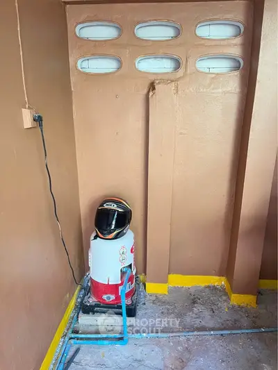 Unique storage space with helmet and water heater in a compact corner