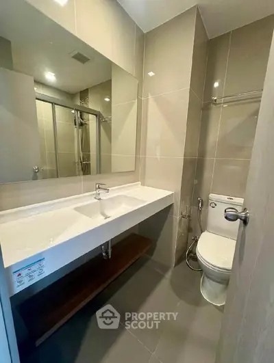 Modern bathroom with sleek fixtures and spacious shower area
