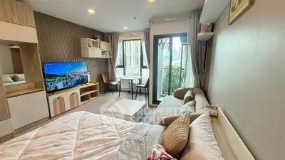 Modern studio apartment with cozy living area and balcony view