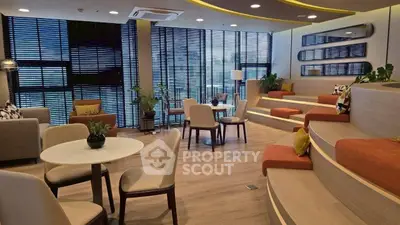 Modern living room with stylish seating and large windows for natural light.