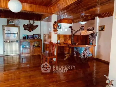 Charming rustic living room with wooden decor and unique furniture pieces.