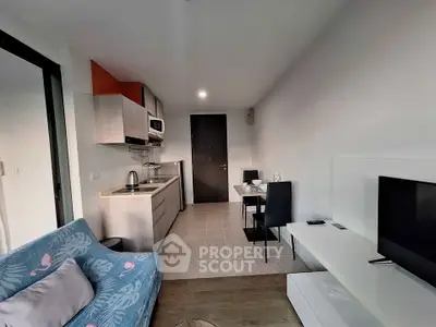 Modern compact living room with open kitchen and stylish decor