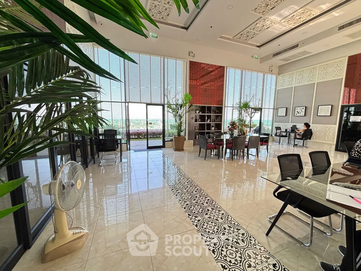 Luxurious modern living room with high ceilings, large windows, and elegant decor.