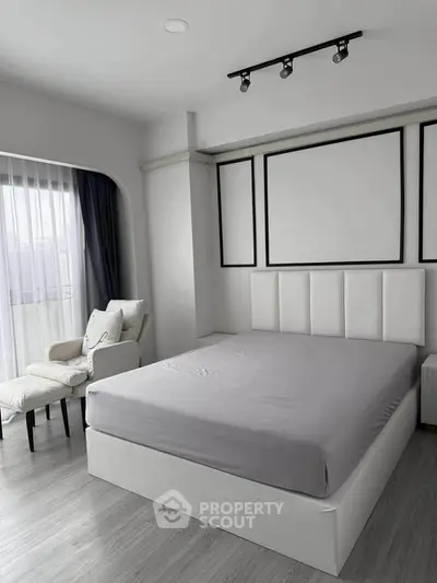 Modern bedroom with stylish decor and natural light