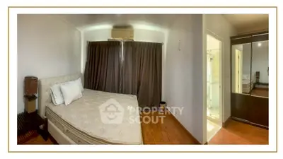Spacious bedroom with elegant decor and ample natural light, featuring a comfortable bed and stylish wardrobe.