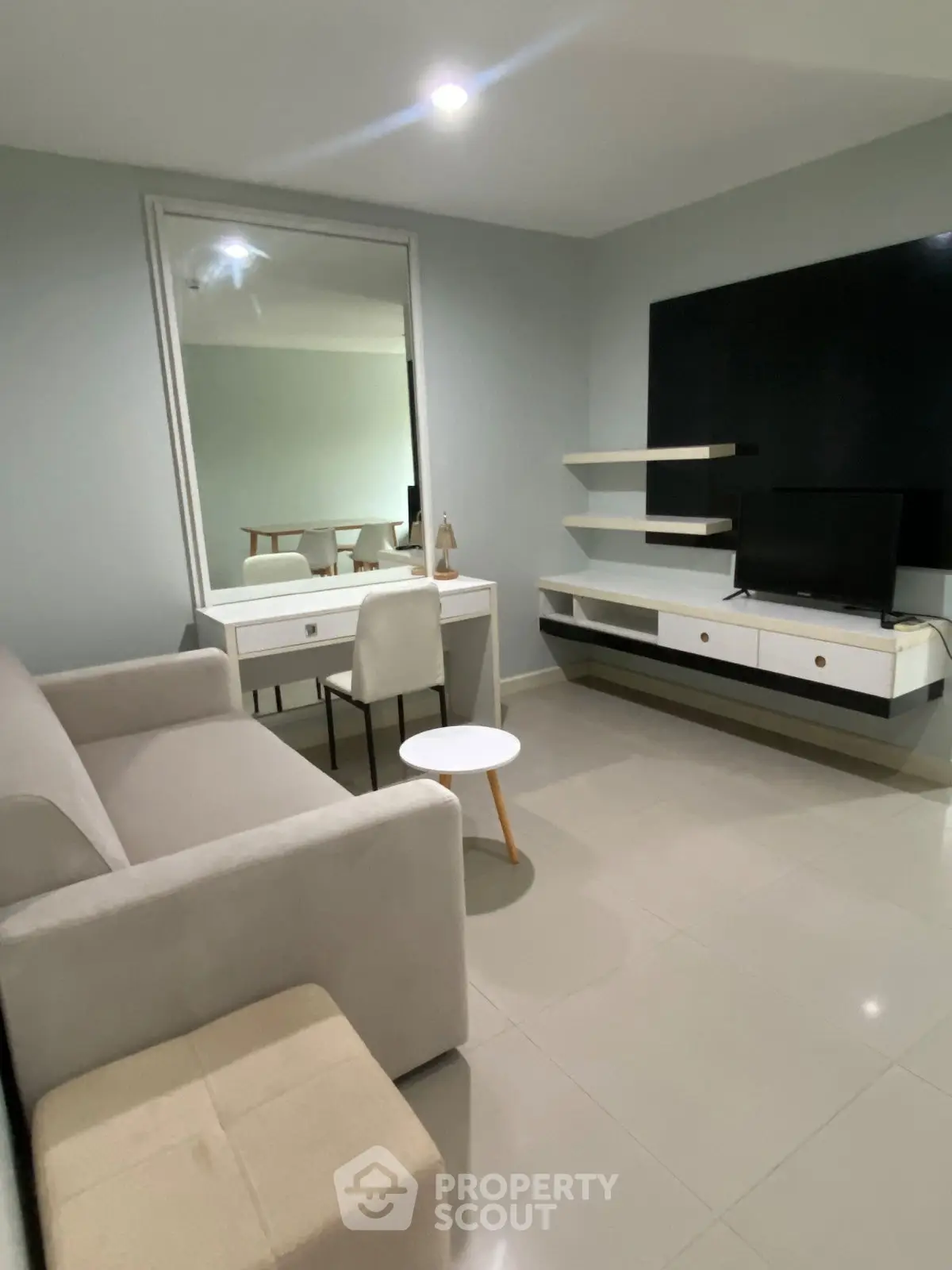 Modern living room with sleek furniture and neutral tones, perfect for relaxation and entertainment.