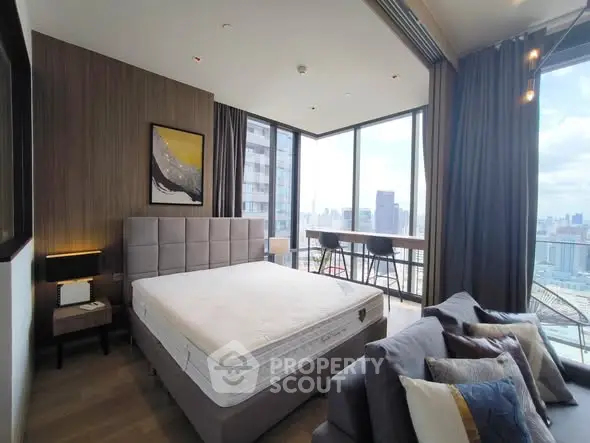 Luxurious bedroom with stunning city view and modern decor in high-rise apartment.