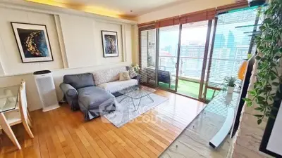 Chic living room with city view, hardwood floors, and stylish decor in modern apartment.