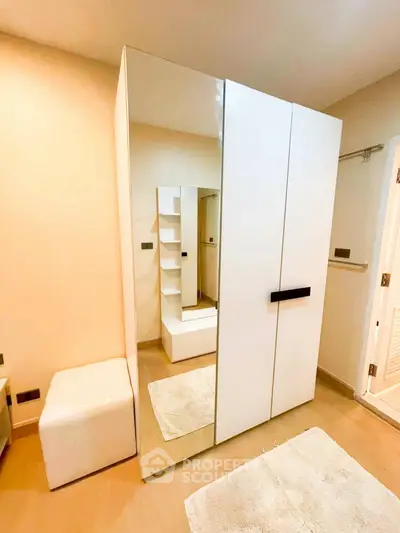 Modern bedroom with sleek wardrobe and cozy decor