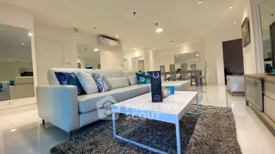 Spacious modern living room with elegant decor and plush seating in a luxury apartment.