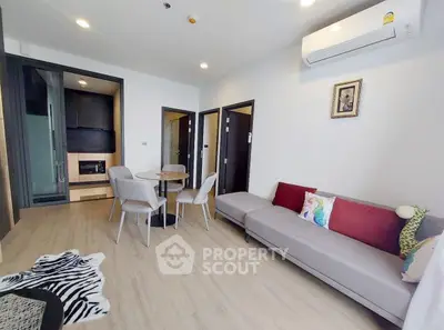 Modern living room with stylish decor and open kitchen layout in a contemporary apartment.