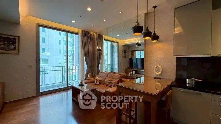 Modern living room with open kitchen and balcony view in luxury apartment