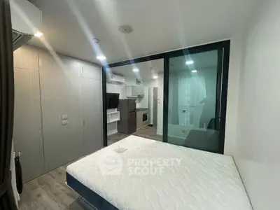 Modern bedroom with glass partition and sleek storage solutions
