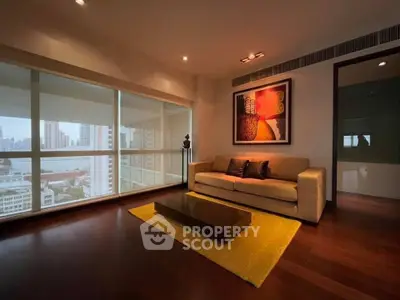 Luxurious living room with city view, modern decor, and cozy ambiance.
