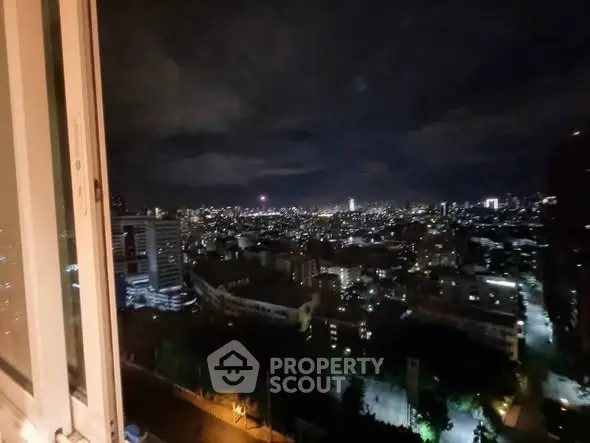 Stunning cityscape night view from high-rise apartment window