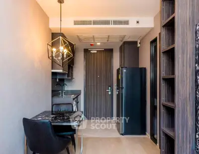 Modern kitchen with sleek design and stylish lighting in a contemporary apartment.