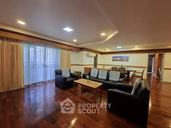Spacious living room with elegant wooden flooring and modern furniture