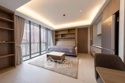 Modern studio apartment with open layout and large windows