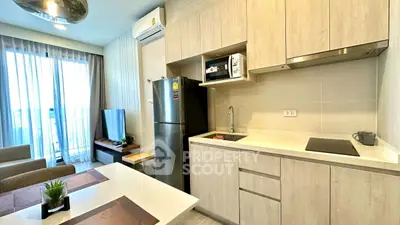 Modern kitchen with sleek appliances and open layout in stylish apartment