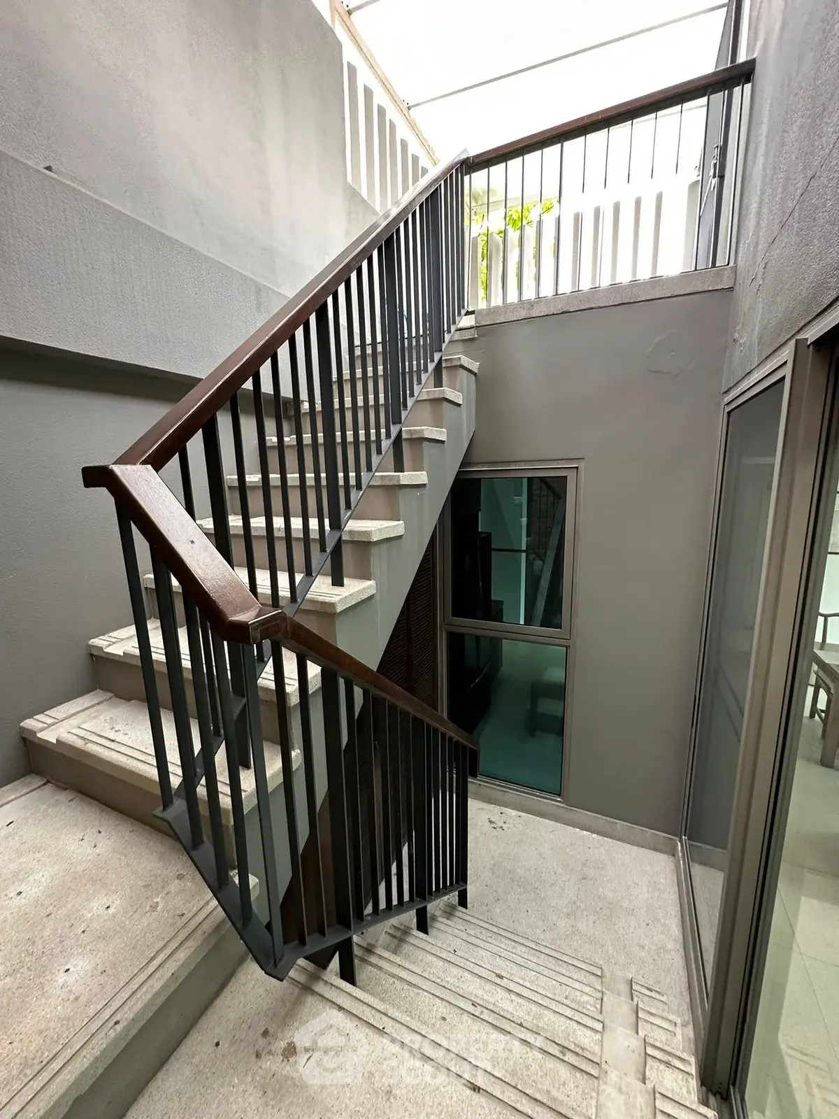 Modern staircase with sleek design and natural lighting in a contemporary building.