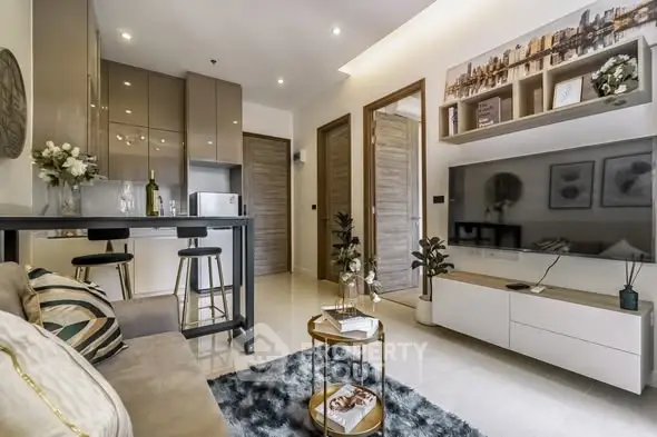 Modern living room with open kitchen, stylish decor, and cozy seating area in a contemporary apartment.
