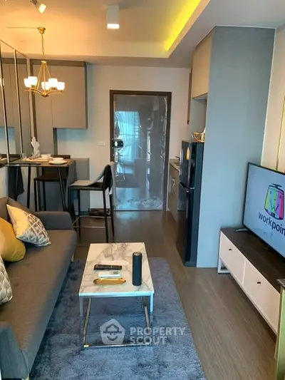 Modern living room with stylish decor, cozy seating, and sleek TV setup in a contemporary apartment.
