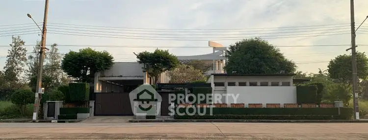 Modern luxury home with lush greenery and sleek design, perfect for upscale living.